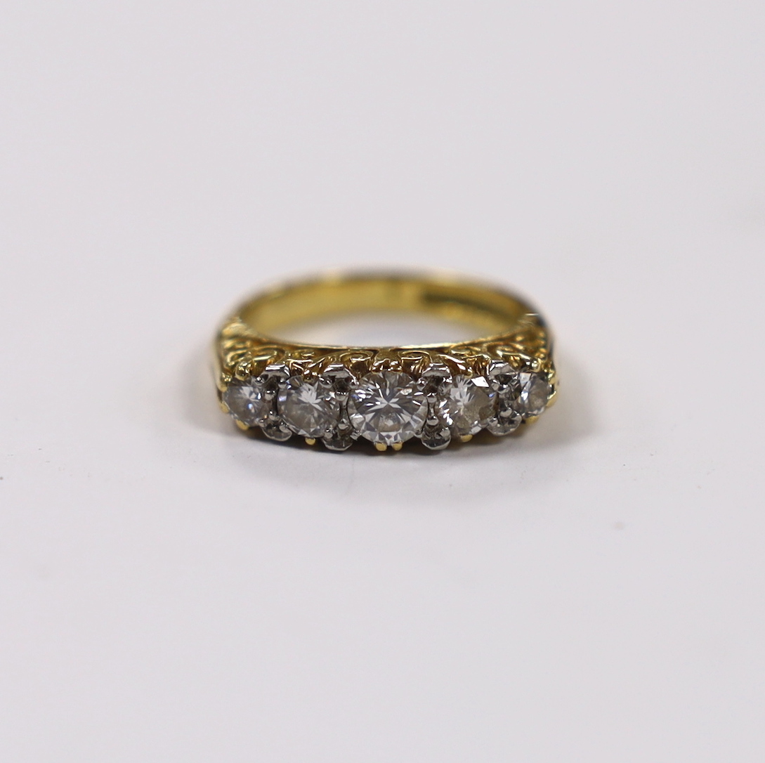 A modern 18ct gold and graduated five stone diamond set half hoop ring, size G, gross weight 5.2 grams.